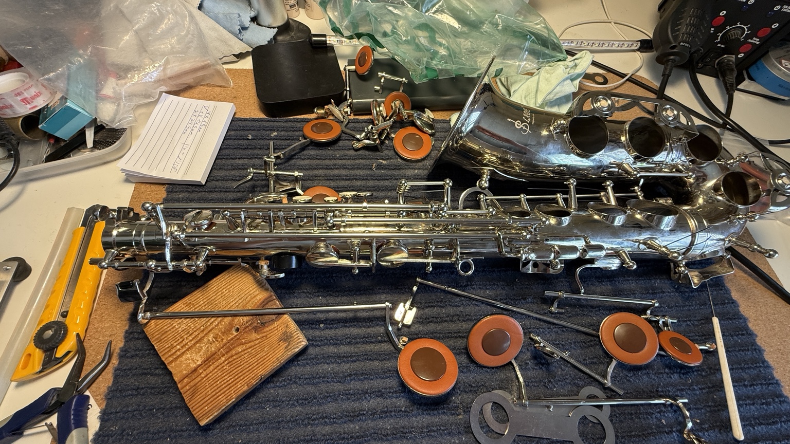 Saxophone undergoing repair and adjustment at Daniel Sinchuk's workbench